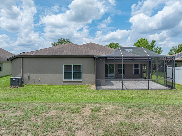 6957 Boulder Run Loop, Wesley Chapel, FL 33545 - back of house with central air condition unit, a patio, stucco siding, glass enclosure, and roof with shingles