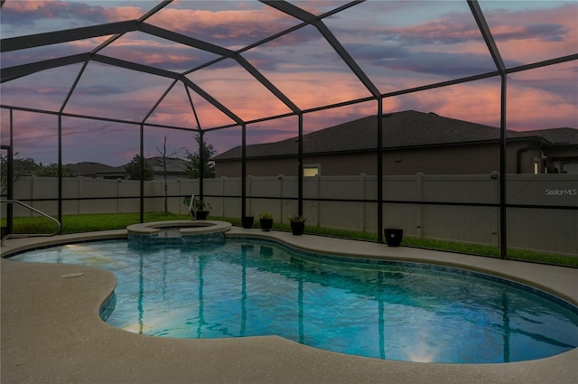 18696 Malinche Loop, Spring Hill, FL 34610 - pool at dusk with a pool with connected hot tub and a patio