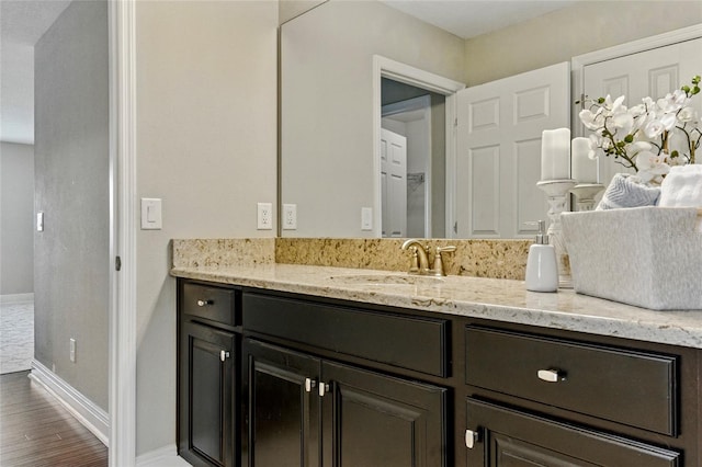 18696 Malinche Loop, Spring Hill, FL 34610 - bathroom with baseboards, wood finished floors, and vanity