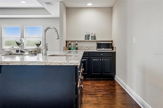 18696 Malinche Loop, Spring Hill, FL 34610 - kitchen featuring a sink, dark wood-style flooring, light stone counters, baseboards, and recessed lighting