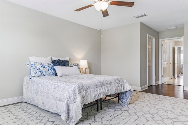 18696 Malinche Loop, Spring Hill, FL 34610 - bedroom featuring baseboards, wood finished floors, and ceiling fan