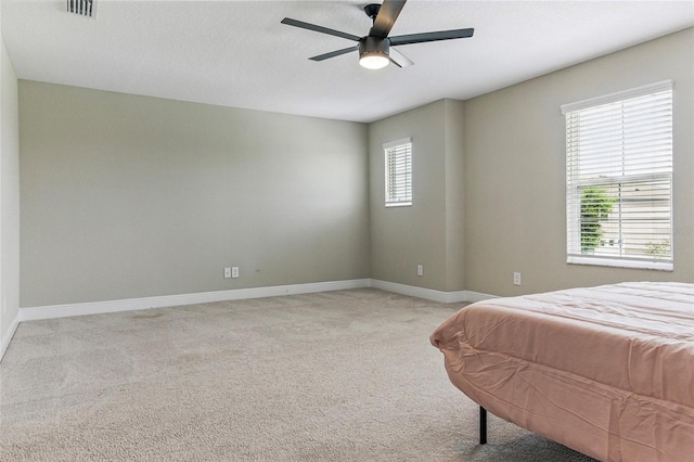 18696 Malinche Loop, Spring Hill, FL 34610 - bedroom featuring baseboards, light colored carpet, and a ceiling fan