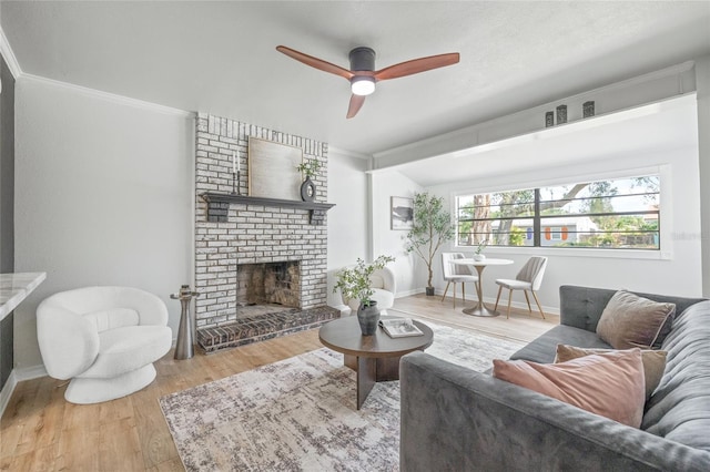 5622 Tangerine Ave S, Gulfport, FL 33707 - living room featuring ceiling fan, wood finished floors, crown molding, baseboards, and a fireplace