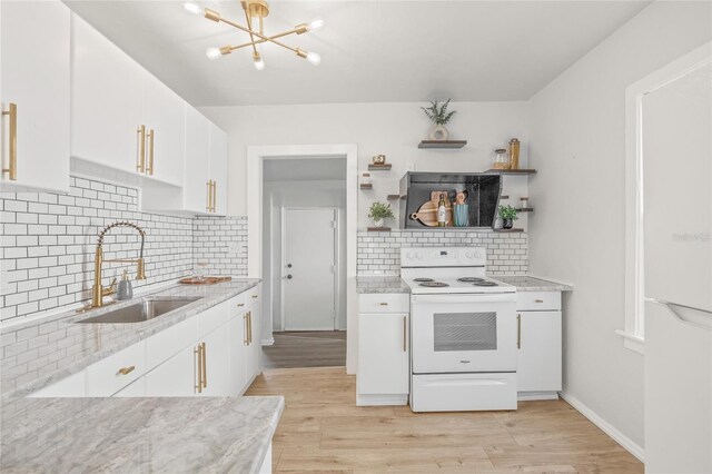 5622 Tangerine Ave S, Gulfport, FL 33707 - kitchen featuring white electric range oven, a sink, white cabinets, and light wood-style floors