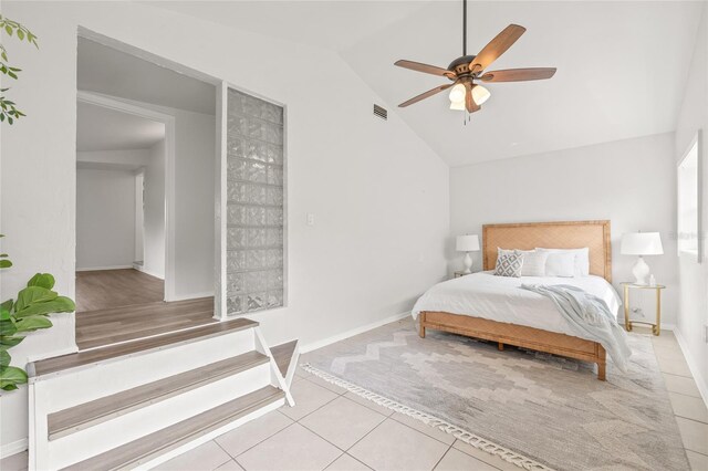 5622 Tangerine Ave S, Gulfport, FL 33707 - bedroom with tile patterned floors, lofted ceiling, a ceiling fan, and baseboards