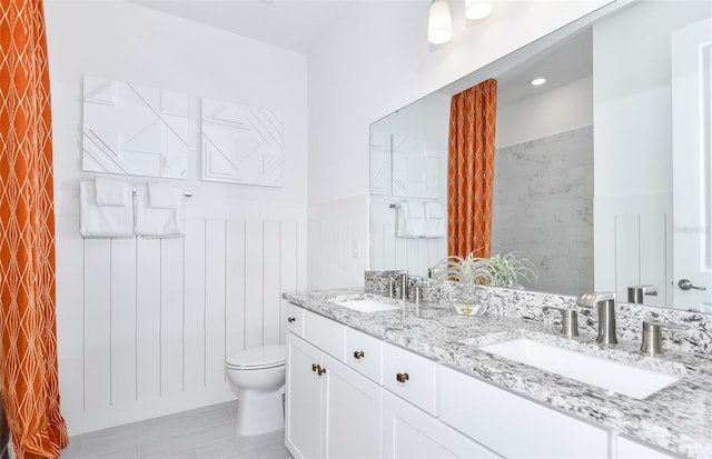 1576 Valier Pt, Zephyrhills, FL 33541 - bathroom with double vanity and a wainscoted wall