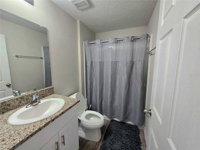 1368 Axel Cir, Winter Haven, FL 33880 - full bath with vanity, a textured ceiling, and wood finished floors