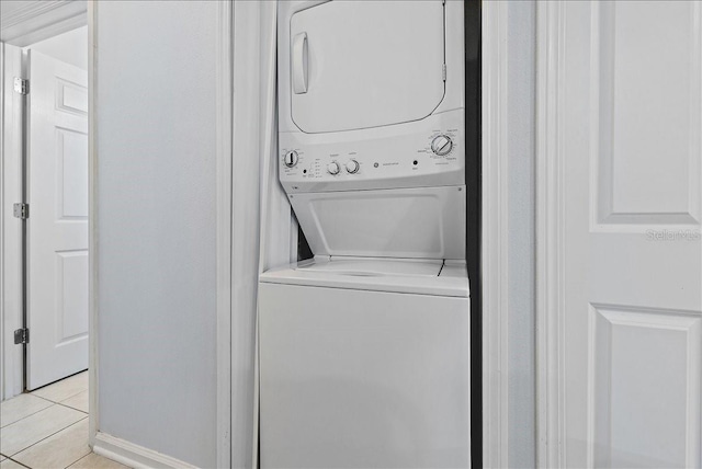 4998 Key Lime Dr Unit 103, Jacksonville, FL 32256 - laundry room featuring estacked washer and dryer, light tile patterned floors, and baseboards