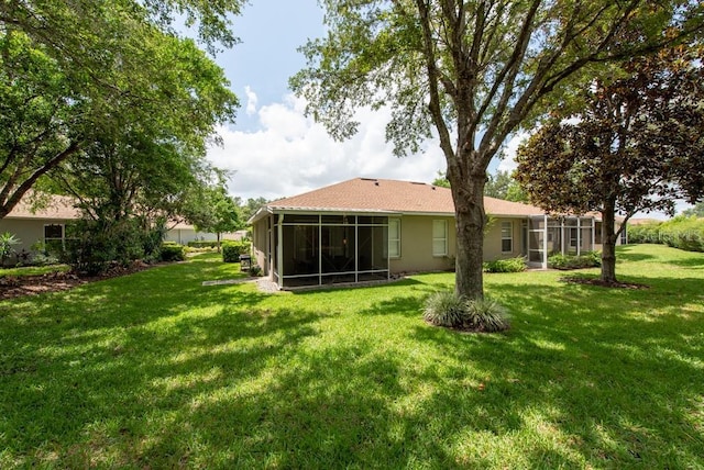 4228 Silver Star Dr, Spring Hill, FL 34609 - rear view of house with a sunroom and a yard