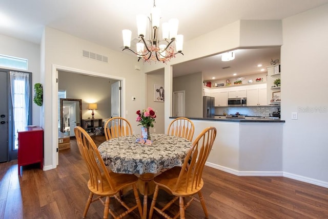 4228 Silver Star Dr, Spring Hill, FL 34609 - dining room featuring dark wood-type flooring, a chandelier, and baseboards