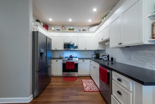4228 Silver Star Dr, Spring Hill, FL 34609 - kitchen with appliances with stainless steel finishes, a sink, dark countertops, white cabinetry, and dark wood-style flooring