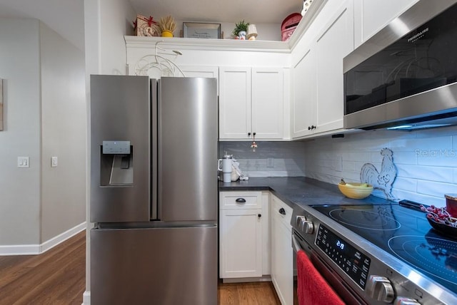 4228 Silver Star Dr, Spring Hill, FL 34609 - kitchen with appliances with stainless steel finishes, dark wood-style flooring, tasteful backsplash, dark countertops, and white cabinetry