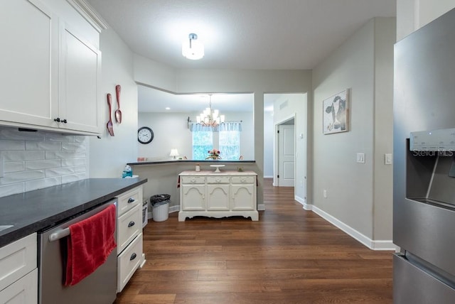 4228 Silver Star Dr, Spring Hill, FL 34609 - kitchen with stainless steel appliances, a chandelier, dark wood-style flooring, and white cabinets