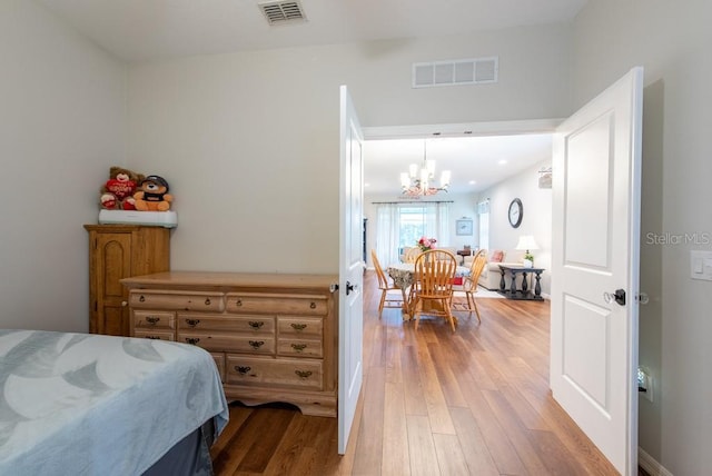 4228 Silver Star Dr, Spring Hill, FL 34609 - bedroom with a chandelier and light wood finished floors
