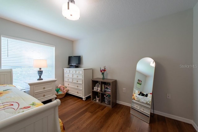 4228 Silver Star Dr, Spring Hill, FL 34609 - bedroom featuring dark wood finished floors and baseboards