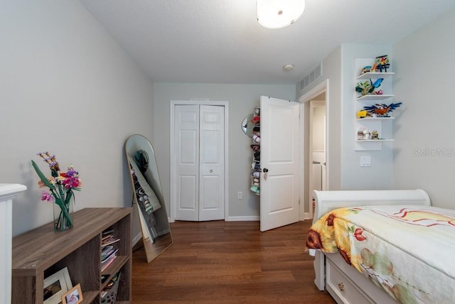 4228 Silver Star Dr, Spring Hill, FL 34609 - bedroom with dark wood-type flooring and a closet
