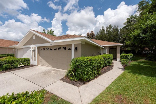 4228 Silver Star Dr, Spring Hill, FL 34609 - view of front of house featuring a garage, stucco siding, a front lawn, and concrete driveway