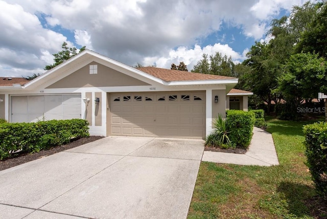 4228 Silver Star Dr, Spring Hill, FL 34609 - single story home featuring driveway, stucco siding, a garage, and a front yard
