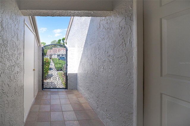 4783 Palermo Ct NE, Saint Petersburg, FL 33703 - doorway with a textured wall and tile patterned flooring