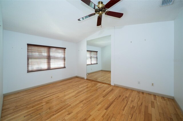 4783 Palermo Ct NE, Saint Petersburg, FL 33703 - unfurnished room with light wood-style flooring, a ceiling fan, lofted ceiling, and baseboards