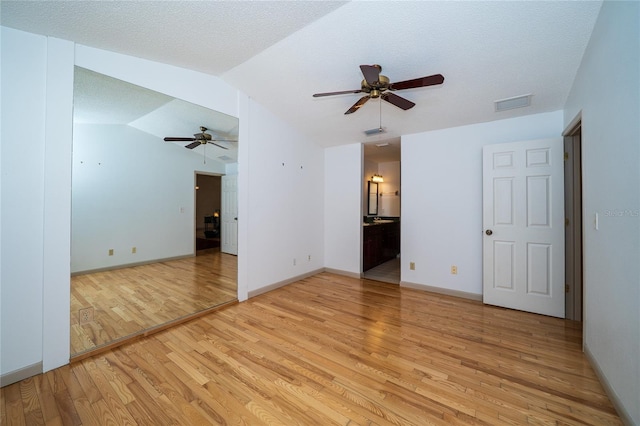 4783 Palermo Ct NE, Saint Petersburg, FL 33703 - unfurnished room with ceiling fan, light wood-type flooring, baseboards, lofted ceiling, and a textured ceiling