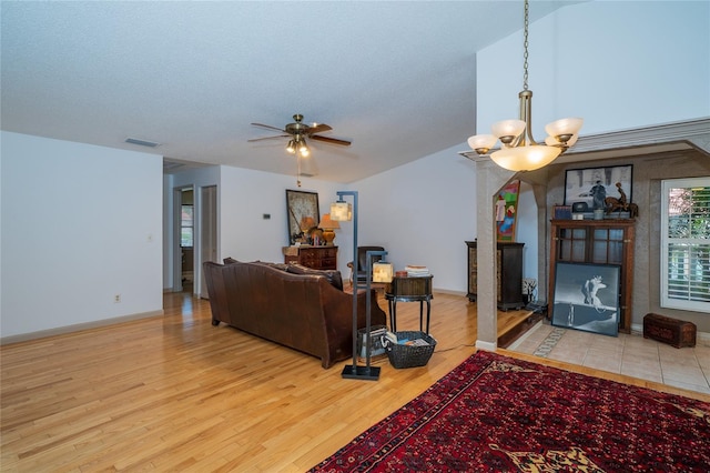 4783 Palermo Ct NE, Saint Petersburg, FL 33703 - living room featuring ceiling fan, wood finished floors, baseboards, and a chandelier