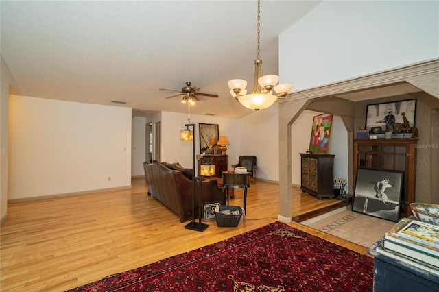 4783 Palermo Ct NE, Saint Petersburg, FL 33703 - living area with wood finished floors, a chandelier, and a ceiling fan