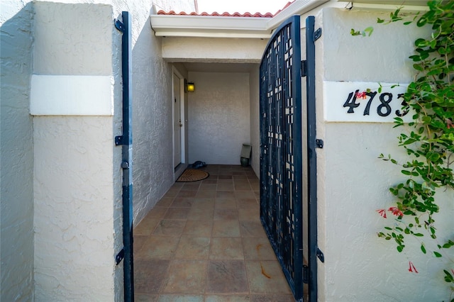 4783 Palermo Ct NE, Saint Petersburg, FL 33703 - property entrance with stucco siding and a tiled roof