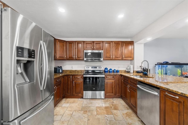 1881 N Hercules Ave Unit 602, Clearwater, FL 33765 - kitchen with stainless steel appliances, a sink, stone tile flooring, stone counters, and recessed lighting
