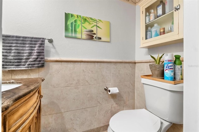 1881 N Hercules Ave Unit 602, Clearwater, FL 33765 - half bath featuring vanity, tile walls, toilet, and wainscoting