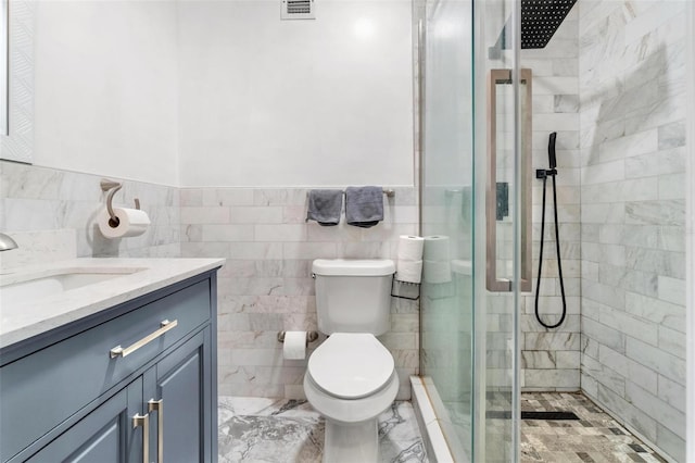 1881 N Hercules Ave Unit 602, Clearwater, FL 33765 - full bathroom featuring a shower stall, vanity, tile walls, toilet, and a wainscoted wall