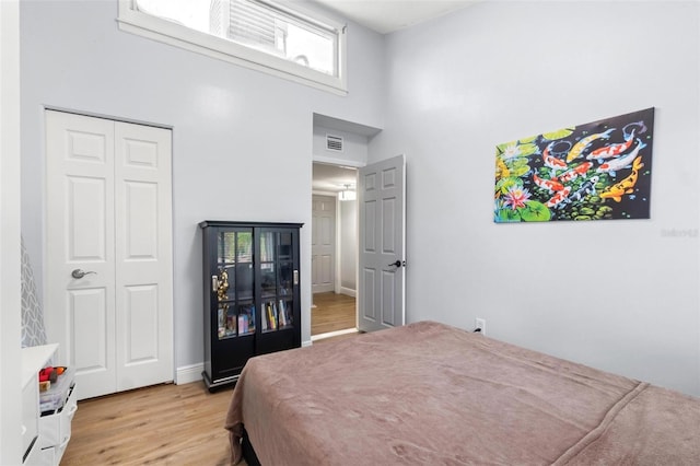 1881 N Hercules Ave Unit 602, Clearwater, FL 33765 - bedroom with a towering ceiling, light wood-style floors, and a closet