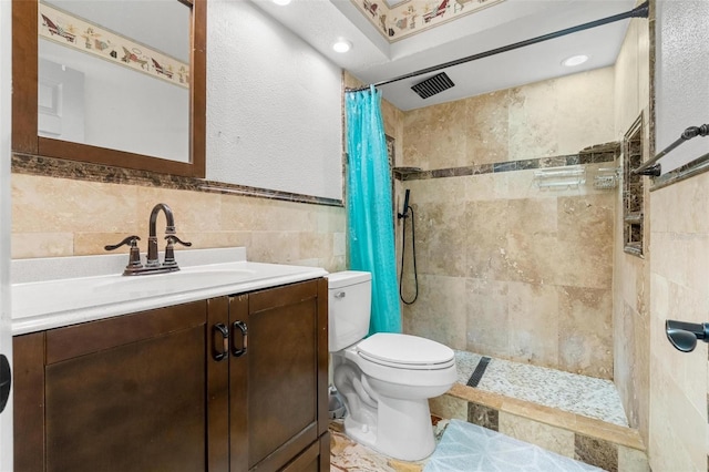 1881 N Hercules Ave Unit 602, Clearwater, FL 33765 - full bath featuring toilet, vanity, tile walls, tiled shower, and a wainscoted wall
