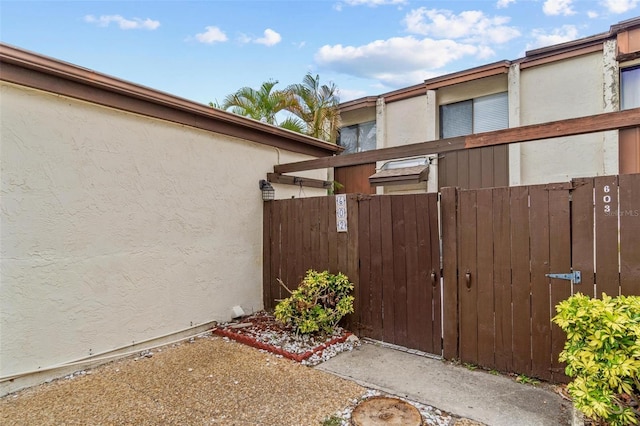 1881 N Hercules Ave Unit 602, Clearwater, FL 33765 - view of side of property featuring stucco siding and a gate