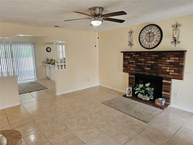 505 Innergary Pl, Valrico, FL 33594 - unfurnished living room featuring a textured ceiling, ceiling fan, tile patterned floors, a fireplace, and baseboards