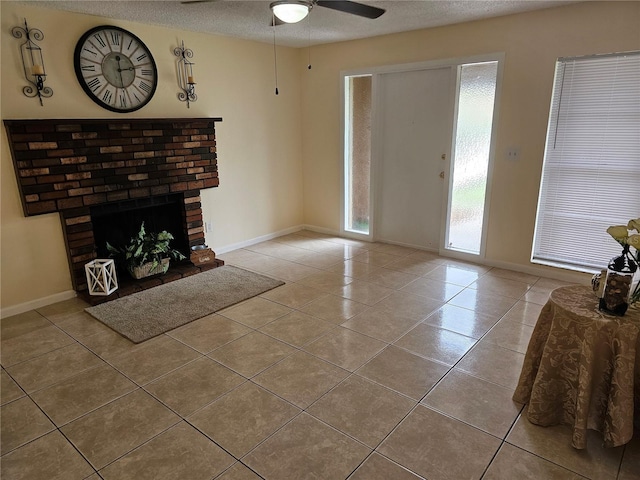 505 Innergary Pl, Valrico, FL 33594 - tiled living area featuring a textured ceiling, a ceiling fan, baseboards, and a brick fireplace
