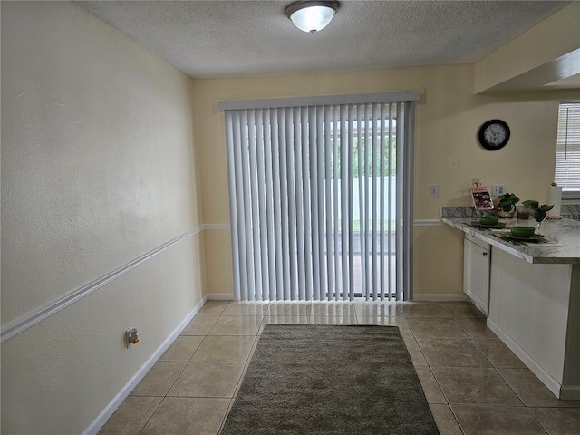 505 Innergary Pl, Valrico, FL 33594 - unfurnished dining area featuring tile patterned floors, a textured ceiling, and baseboards