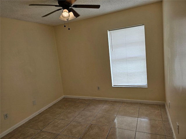 505 Innergary Pl, Valrico, FL 33594 - tiled spare room featuring a ceiling fan, a textured ceiling, and baseboards