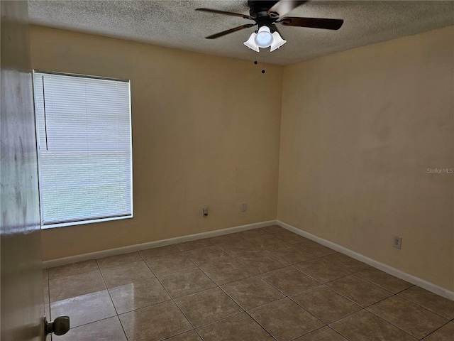 505 Innergary Pl, Valrico, FL 33594 - tiled spare room featuring a textured ceiling, a ceiling fan, and baseboards