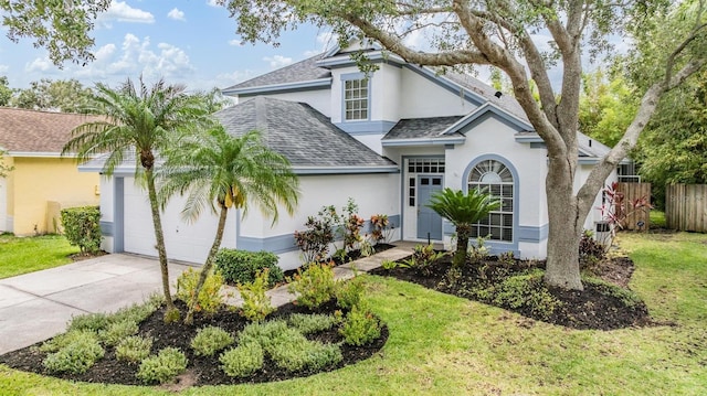 9806 Bennington Dr, Tampa, FL 33626 - view of front of home featuring stucco siding, an attached garage, a shingled roof, and driveway