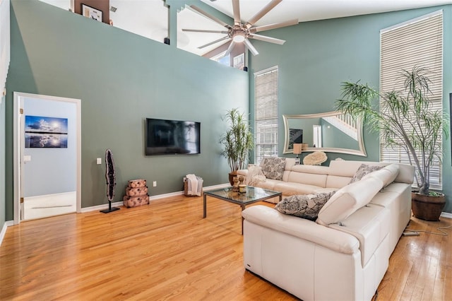 9806 Bennington Dr, Tampa, FL 33626 - living area with a ceiling fan, wood finished floors, high vaulted ceiling, and baseboards