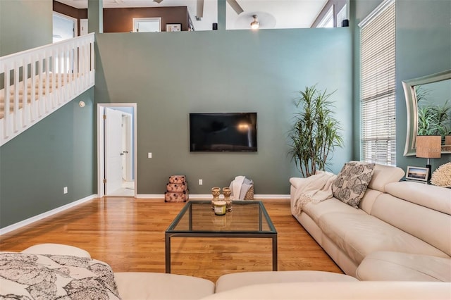 9806 Bennington Dr, Tampa, FL 33626 - living room with wood finished floors, a towering ceiling, and baseboards