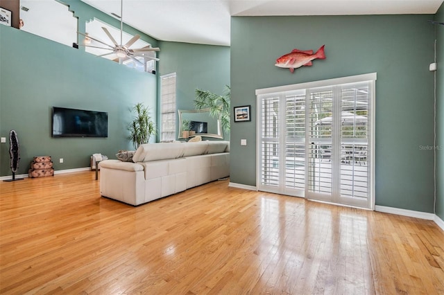 9806 Bennington Dr, Tampa, FL 33626 - living room featuring healthy amount of natural light, hardwood / wood-style flooring, baseboards, and a towering ceiling