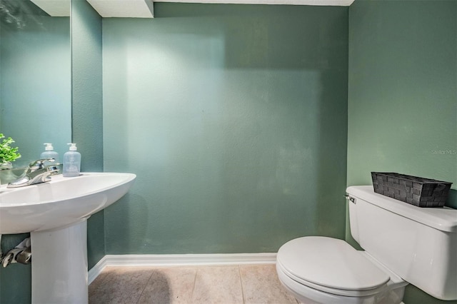 9806 Bennington Dr, Tampa, FL 33626 - half bath with baseboards, toilet, and tile patterned flooring