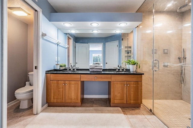 9806 Bennington Dr, Tampa, FL 33626 - bathroom with a shower stall, double vanity, toilet, and tile patterned flooring