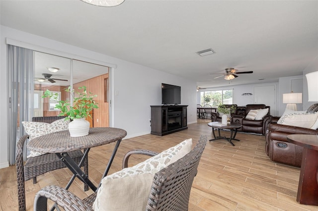 8014 Lotus Dr, Port Richey, FL 34668 - living area featuring a ceiling fan, light wood-style flooring, and a fireplace
