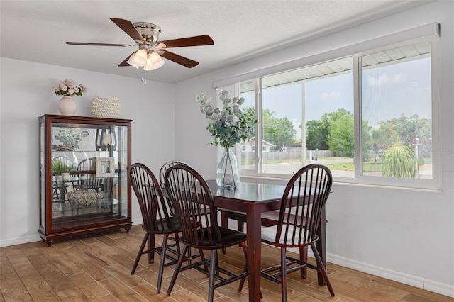 8014 Lotus Dr, Port Richey, FL 34668 - dining area with plenty of natural light, a ceiling fan, and wood finished floors
