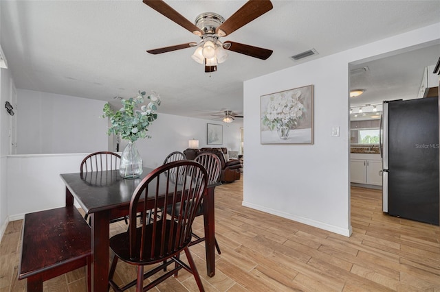 8014 Lotus Dr, Port Richey, FL 34668 - dining room featuring ceiling fan and light wood-type flooring