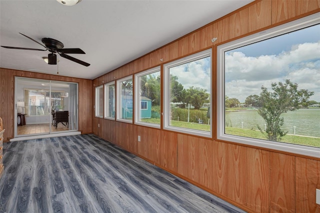 8014 Lotus Dr, Port Richey, FL 34668 - unfurnished sunroom with plenty of natural light, wood walls, and wood finished floors