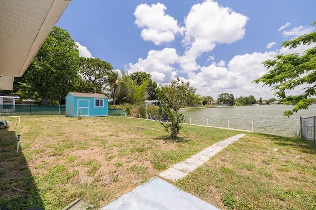 8014 Lotus Dr, Port Richey, FL 34668 - fenced yard with a water view and a storage shed